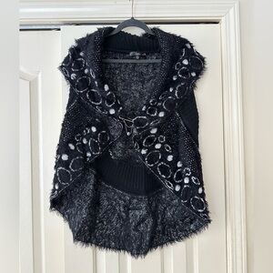 Super soft, stylish, unique sweater vest.Great detail, design, silver pin clasp.